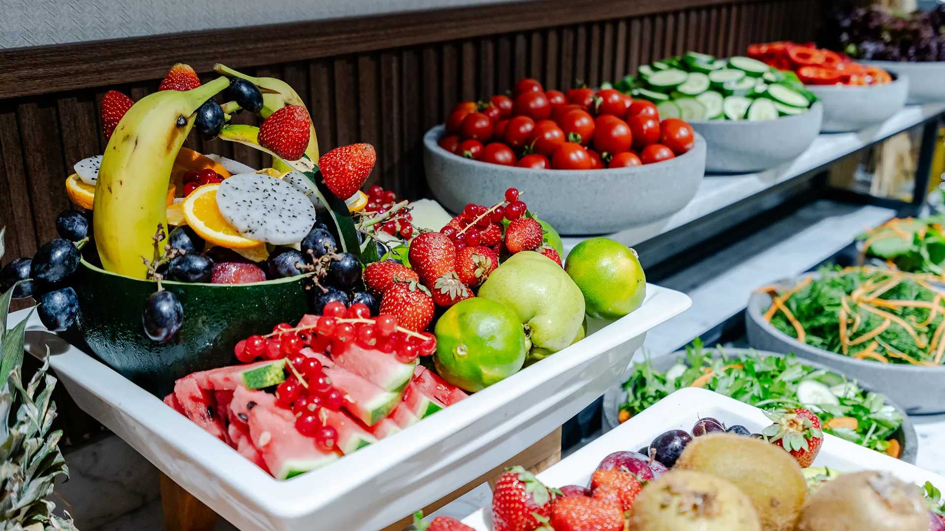 A breakfast buffet with a variety of fruits, including strawberries.